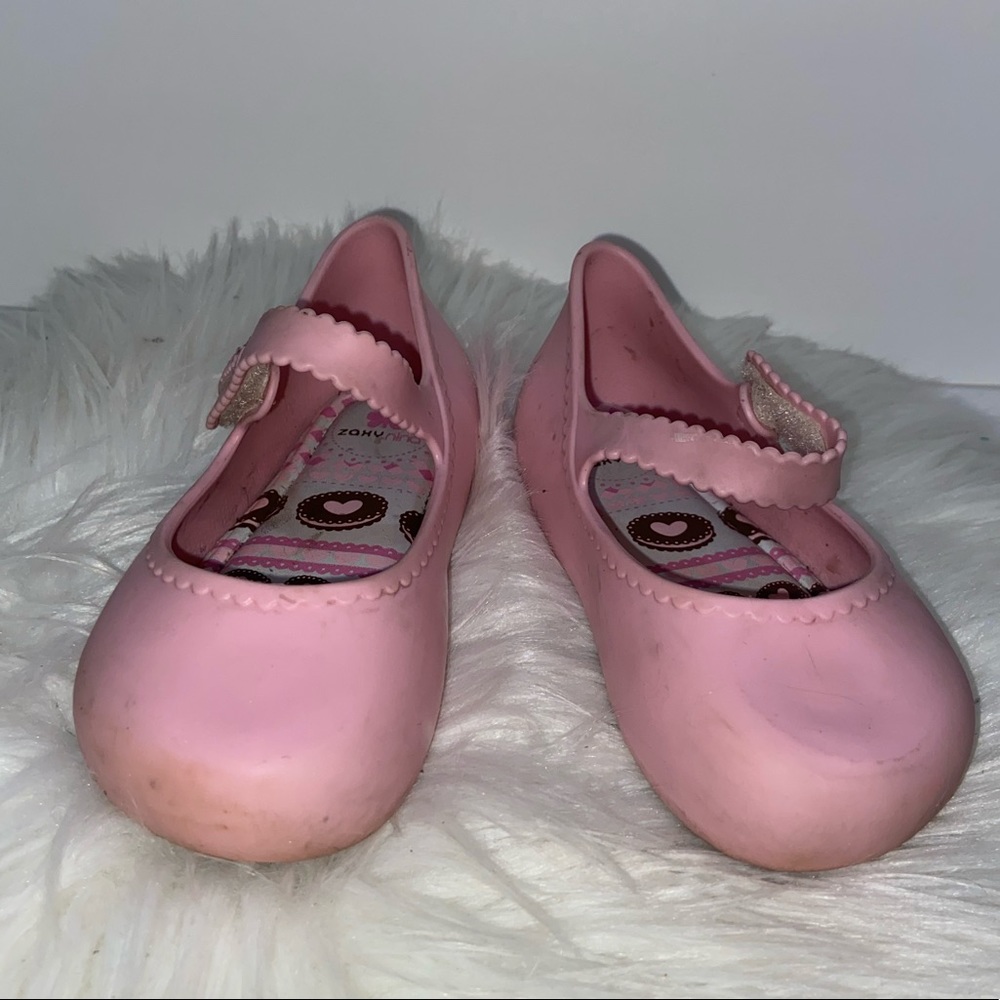 Pink jelly Mary Jane shoes.